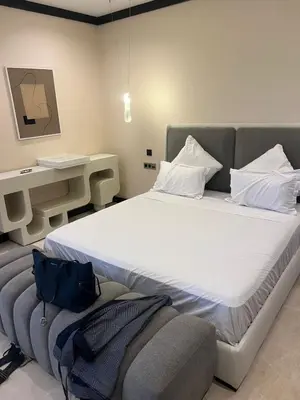 a bedroom with a large bed and a desk at Four Seasons Residences Marrakech in Marrakech