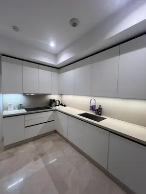 a kitchen with white cabinets and a sink at Four Seasons Residences Marrakech in Marrakech