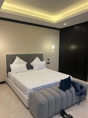 a bedroom with a large bed with a couch at Four Seasons Residences Marrakech in Marrakech