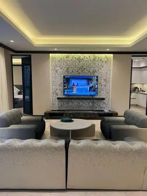 a living room with couches and a flat screen tv at Four Seasons Residences Marrakech in Marrakech
