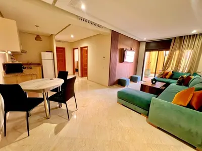 a living room with a couch and a table at Jassman2 in Marrakech