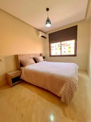 a bedroom with a large bed and a window at Jassman2 in Marrakech