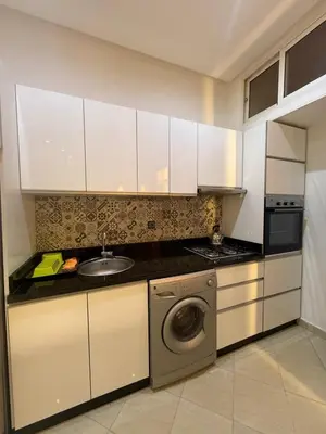 a kitchen with a sink and a washing machine at Résidence touristique Marrakesh in Marrakech