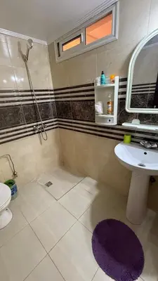 a bathroom with a sink and a toilet and a mirror at Résidence touristique Marrakesh in Marrakech