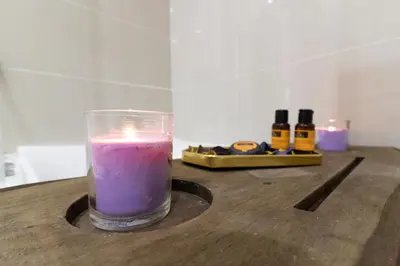 a candle sitting on top of a wooden table at appartement luxe golf prestigia in Marrakech