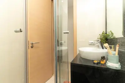 a bathroom with a sink and a glass shower at appartement luxe golf prestigia in Marrakech