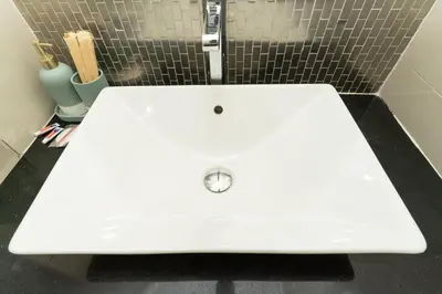 a white bench in a bathroom with a sink at appartement luxe golf prestigia in Marrakech