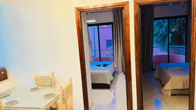 a room with a mirror and a table and a bed at Spacieux appartement juste pour familles réservation juste pour les familles et les couples mariés in Marrakech