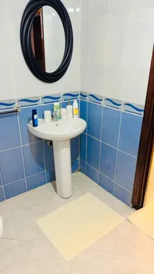 a bathroom with a sink and a mirror at Spacieux appartement juste pour familles réservation juste pour les familles et les couples mariés in Marrakech