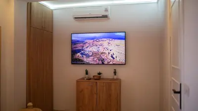 a television hanging on a wall in a room at Cosy Victor hugo in Marrakech