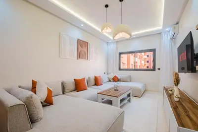 a living room with a couch and a table at 3BR Luxury Stay - Hivernage- Pool View - Parking Near M Avenue & Rail in Marrakech