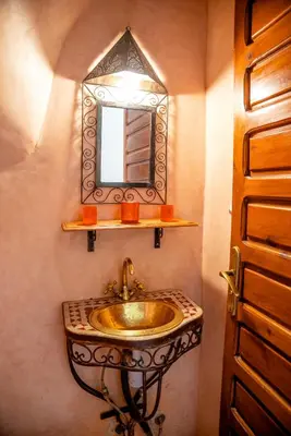 a bathroom with a sink and a mirror at Riad Palm and Pool 2 in Marrakech