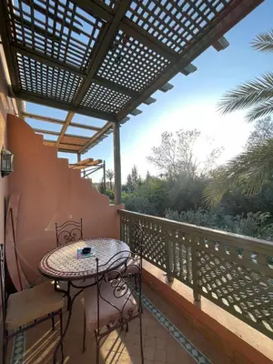 a patio with a table and chairs on a balcony at Ma kech house in Marrakech