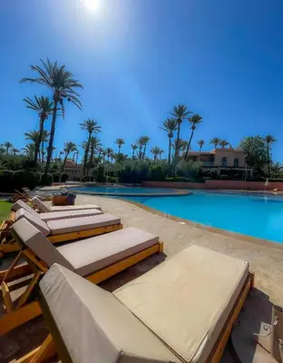a swimming pool with chaise lounges and a swimming pool at Ma kech house in Marrakech