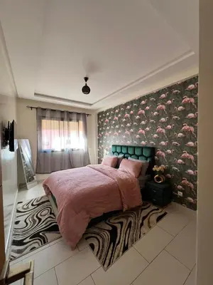 a bedroom with a large bed and a wall with flamingos at Global riad nawal in Marrakech