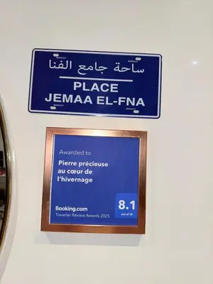 a sign for the place jamaica el fixa on a wall at appartement familial in Marrakech