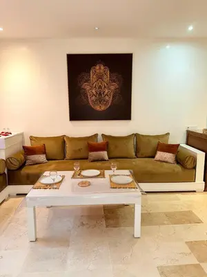 a living room with a couch and a table at appartement familial in Marrakech