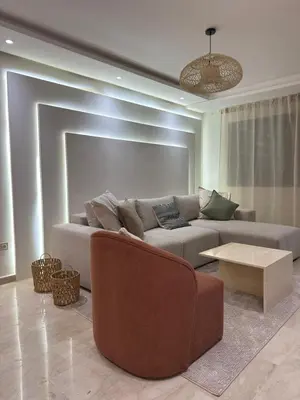 a living room with a couch and a table at Magnifique appart Moderne 2ch 4pax Tout Confort in Marrakech