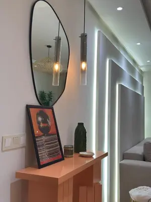 a living room with a mirror and a table at Magnifique appart Moderne 2ch 4pax Tout Confort in Marrakech