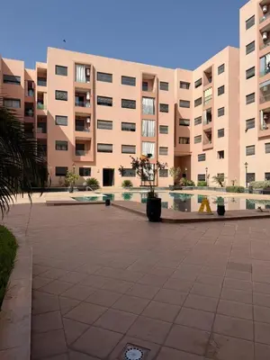 a large building with a courtyard in front of it at Magnifique appart Moderne 2ch 4pax Tout Confort in Marrakech