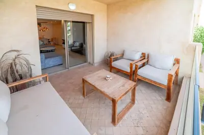 a patio with two chairs and a coffee table at Prestige de luxe avec piscine in Marrakech