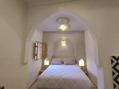a bedroom with a bed with two pillows at Riad E&J Marrakech Médina 5 ch climatisées, piscine chauffée, EXCLUSIF in Marrakech