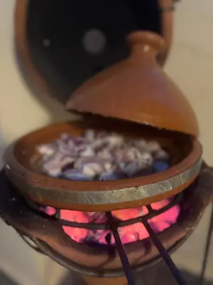 a pot of food is cooking in a stove at Riad E&J Marrakech Médina 5 ch climatisées, piscine chauffée, EXCLUSIF in Marrakech