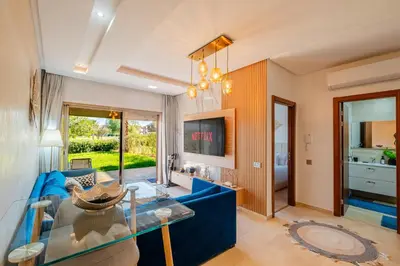 a living room with a blue couch and a glass table at Luxury Stay - Prestigia Golf City-3min - Airport in Marrakech
