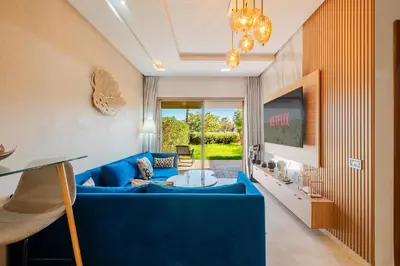 a living room with a blue couch at Luxury Stay - Prestigia Golf City-3min - Airport in Marrakech