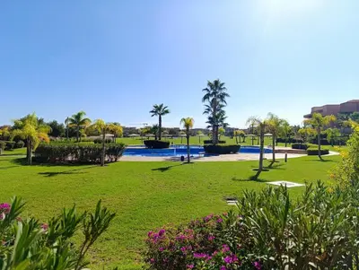 a park with a pool and palm trees and flowers at Luxury Stay - Prestigia Golf City-3min - Airport in Marrakech