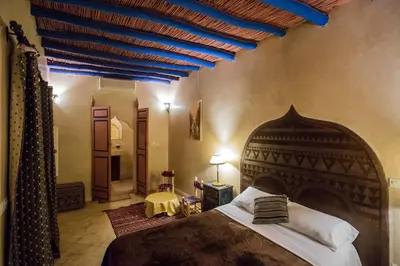 a bedroom with a large bed with a blue ceiling at Riad Light Of Sun in Marrakech