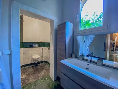 a bathroom with a tub and a sink and a mirror at Villa luxueuse marrakech in Marrakech