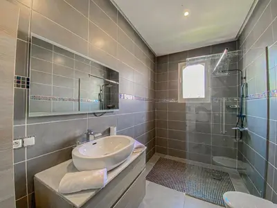 a bathroom with a sink and a glass shower at Villa luxueuse marrakech in Marrakech