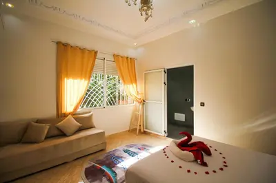 a living room with a bed and a couch at Redmoon Villa & Riad in Marrakech