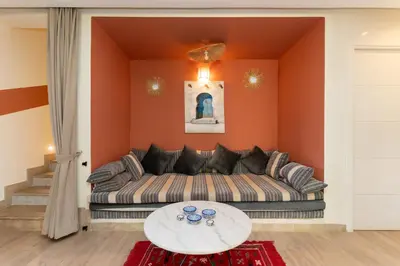 a living room with a couch and a table at Villa centre Marrakech piscine sans vis-à-vis et Jacuzzi in Marrakech
