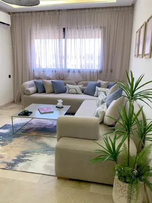 a living room with a couch and a table at Nejma House - 1 BR with pool in Marrakech