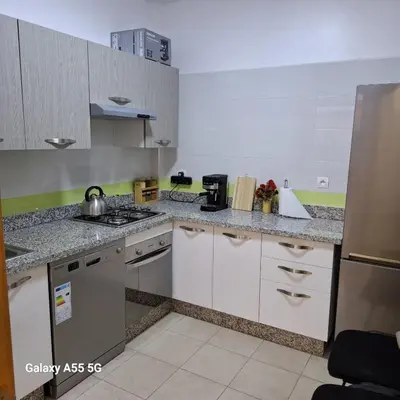 a kitchen with white cabinets and a stove at Douira in Marrakech
