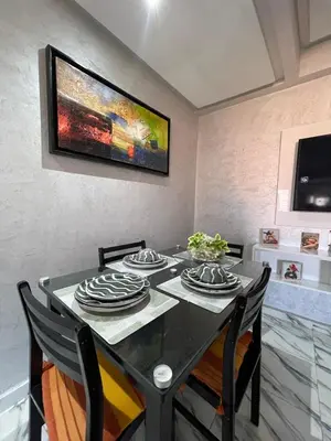 a dining room with a black table and chairs at Gone app Marrakech in Marrakech