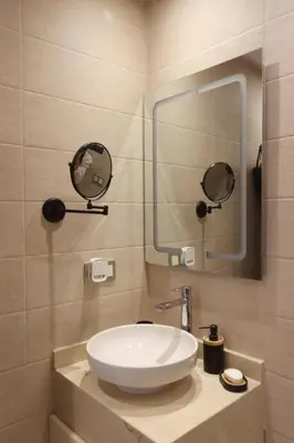 a bathroom with a white sink and a mirror at Modern top floor apartment with balcony! in Marrakech