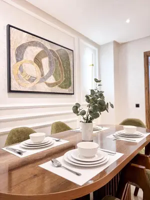 a dining room with a wooden table and chairs at Stylish Escape Modern Comforts in Marrakech