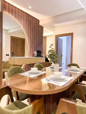 a dining room with a wooden table and chairs at Stylish Escape Modern Comforts in Marrakech