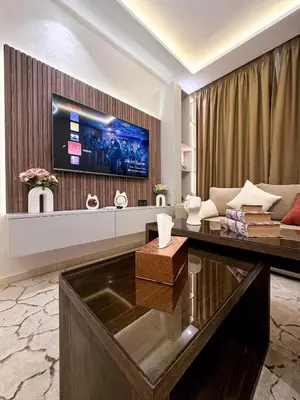 a living room with a couch and a tv on a wall at Stylish Escape Modern Comforts in Marrakech
