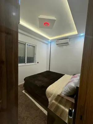 a bedroom with a bed with a red light on the ceiling at Piso en Marrakech in Marrakech