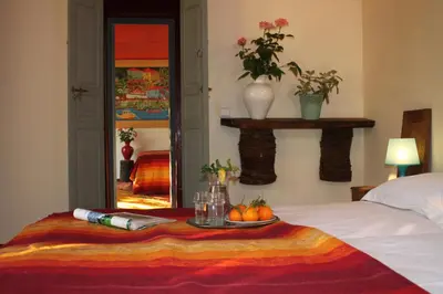 a bed with a table with a plate of fruit on it at villa hibiscus marrakech in Marrakech