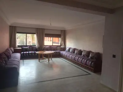 a living room with a couch and a table at Chic 2BR Apartment with Beautiful Moroccan Salon in Marrakech