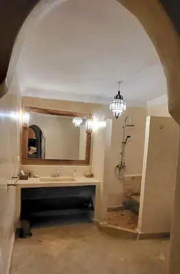 a bathroom with a sink and a mirror at Riad Bouchra, riad privatif proche de la place Jemaa-El-Fna in Marrakech