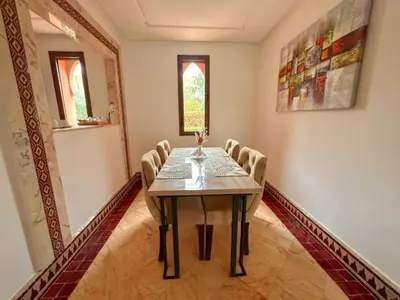 a dining room with a table and chairs at Riador in Marrakech