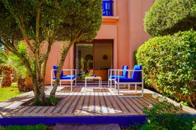 a group of blue chairs sitting on a patio at Riador in Marrakech