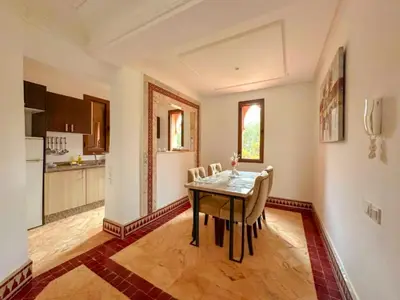 a kitchen and dining room with a table and chairs at Riador in Marrakech
