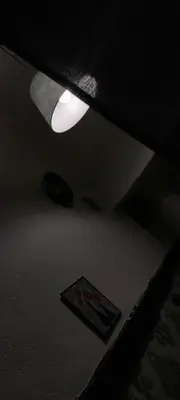 a ceiling light in a dark room with a rug at Riad 05 in Marrakech